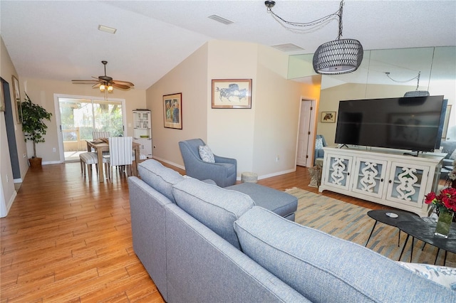 living room featuring vaulted ceiling, ceiling fan, and light hardwood / wood-style floors