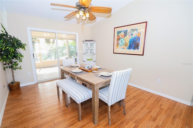 dining room featuring ceiling fan, lofted ceiling, and light hardwood / wood-style flooring