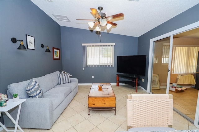 tiled living room with vaulted ceiling, a textured ceiling, and ceiling fan