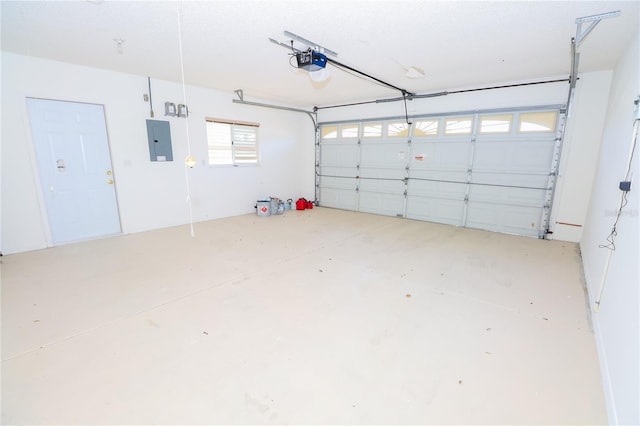 garage with a garage door opener and electric panel