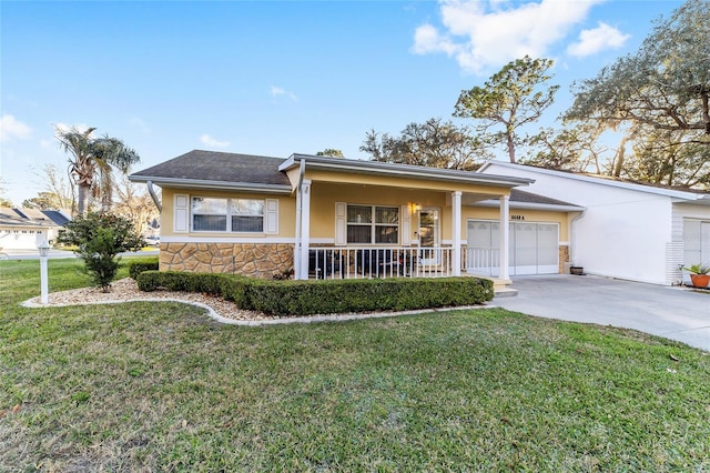 ranch-style home featuring a garage, covered porch, and a front lawn