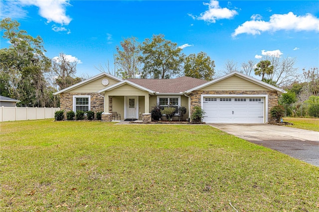 ranch-style house featuring a garage and a front yard