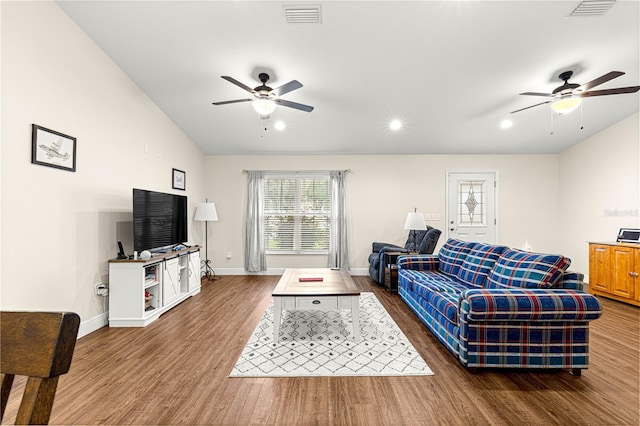 living room featuring ceiling fan, dark hardwood / wood-style flooring, and vaulted ceiling