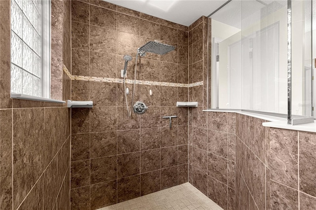 bathroom with a tile shower