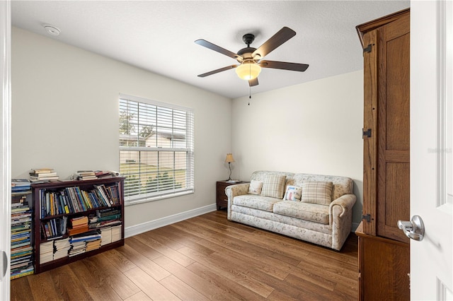 sitting room featuring dark hardwood / wood-style floors and ceiling fan