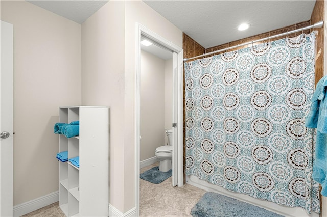 bathroom with a textured ceiling and toilet