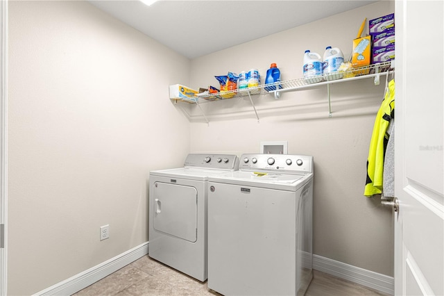 laundry room featuring washer and dryer and light tile patterned floors