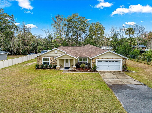 ranch-style home with a garage and a front lawn