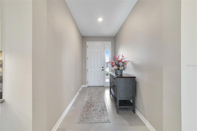 doorway to outside with light tile patterned flooring