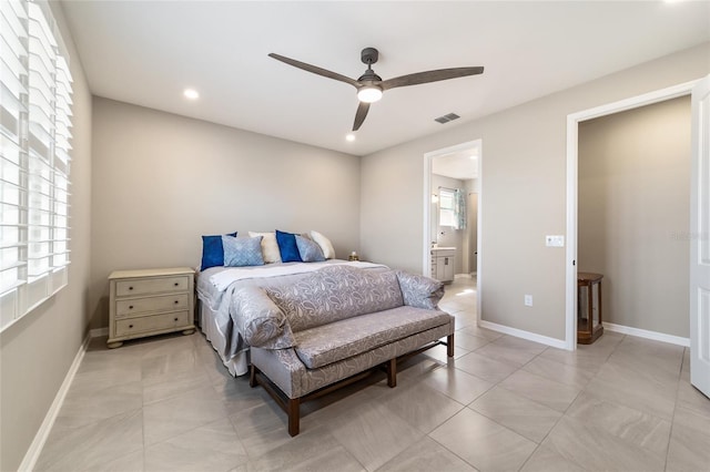 tiled bedroom featuring connected bathroom and ceiling fan