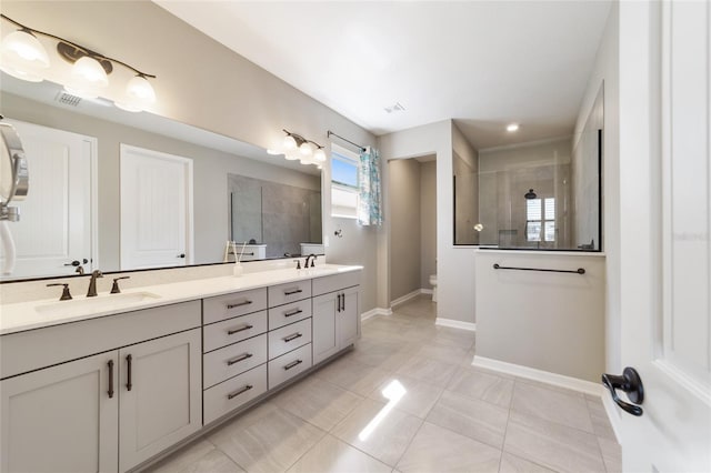 bathroom with vanity, a tile shower, tile patterned floors, and toilet