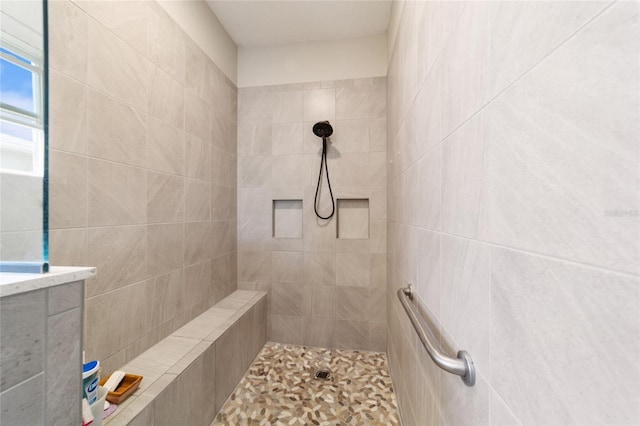 bathroom with tiled shower