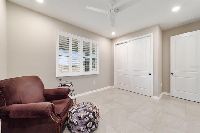 living area featuring ceiling fan