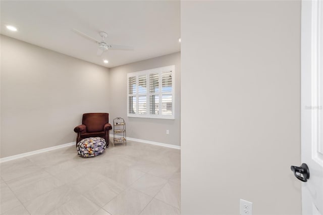 living area with light tile patterned floors and ceiling fan