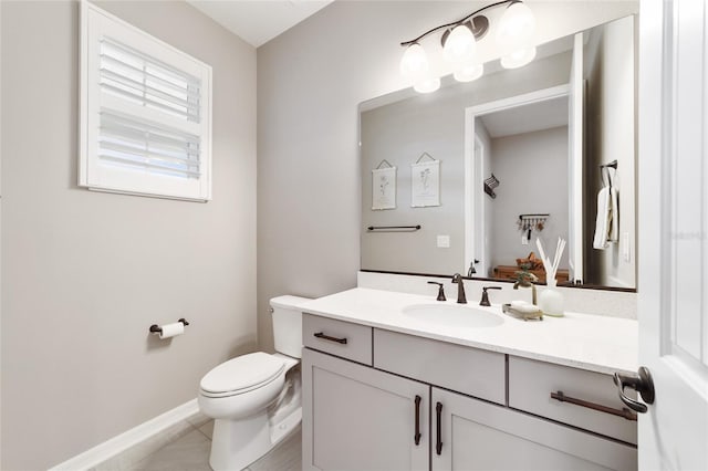 bathroom with tile patterned flooring, vanity, and toilet