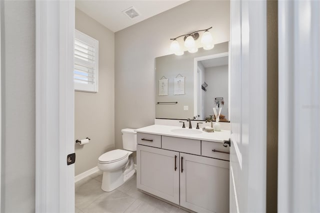 bathroom featuring vanity, tile patterned floors, and toilet