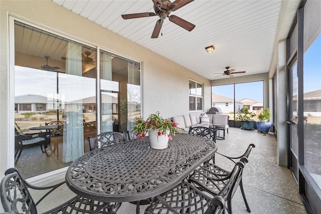 sunroom / solarium with plenty of natural light and ceiling fan