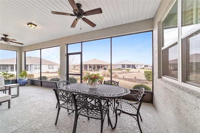 sunroom featuring ceiling fan and a healthy amount of sunlight