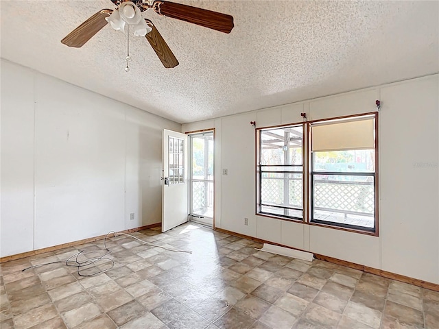 spare room featuring a baseboard heating unit and a textured ceiling