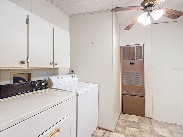 clothes washing area featuring ceiling fan, a textured ceiling, cabinets, and washing machine and clothes dryer