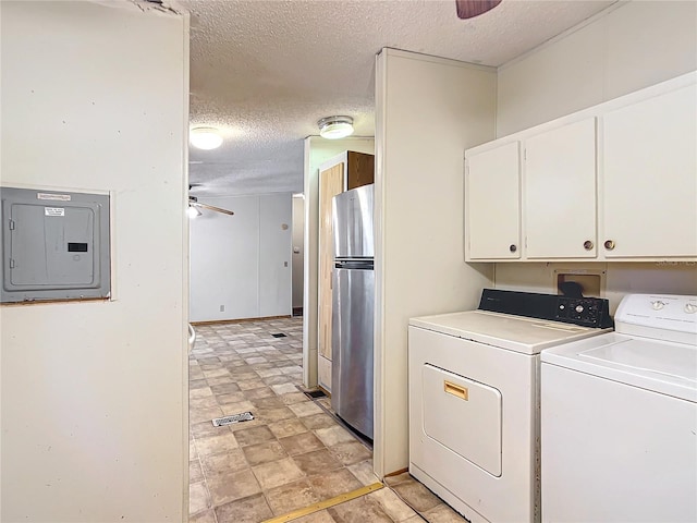 washroom featuring washer and clothes dryer, ceiling fan, electric panel, cabinets, and a textured ceiling