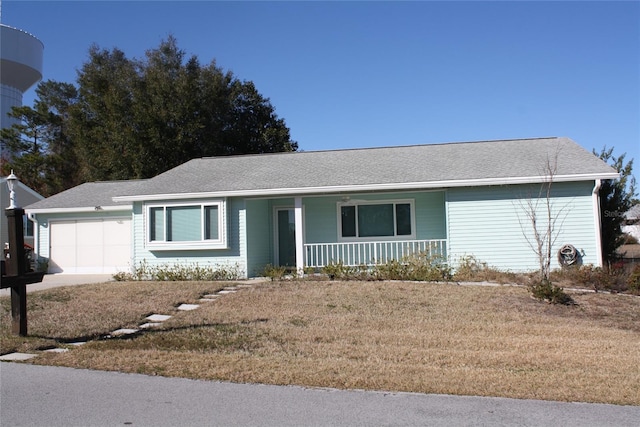 ranch-style home with a garage, a porch, and a front yard