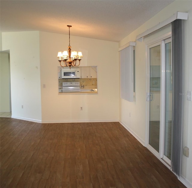 interior space featuring dark hardwood / wood-style flooring, a notable chandelier, and a textured ceiling