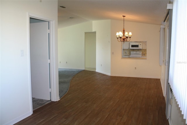 empty room with lofted ceiling, dark hardwood / wood-style flooring, and a chandelier