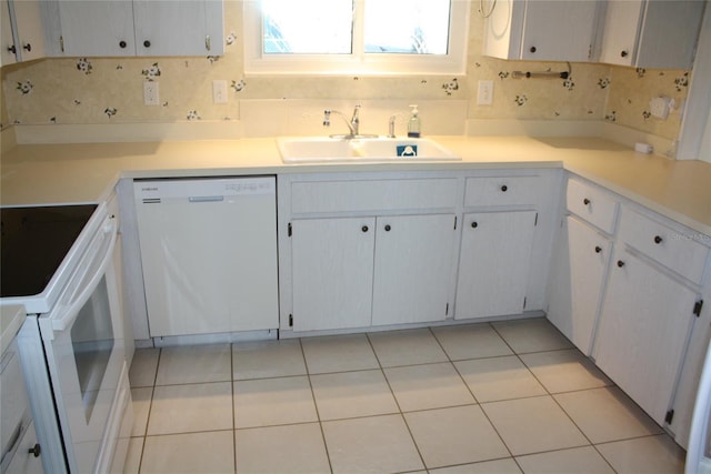 kitchen featuring light tile patterned flooring, white appliances, sink, and white cabinets