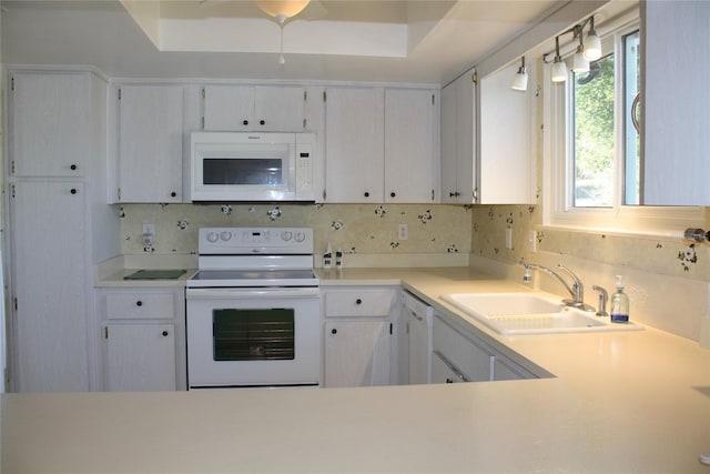 kitchen featuring tasteful backsplash, sink, white appliances, and white cabinets