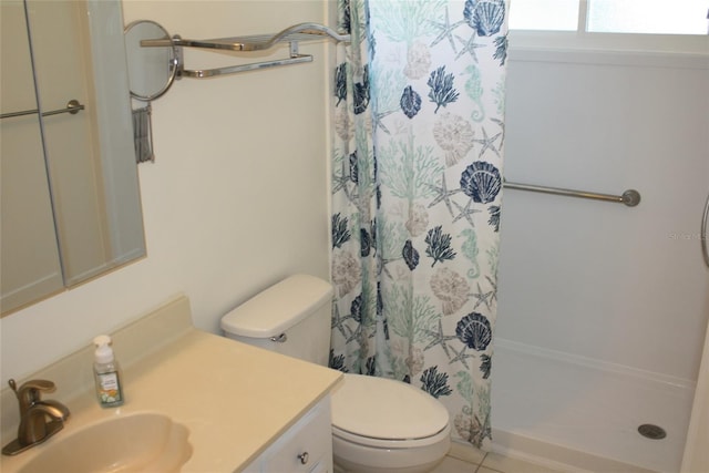 bathroom featuring tile patterned flooring, vanity, curtained shower, and toilet