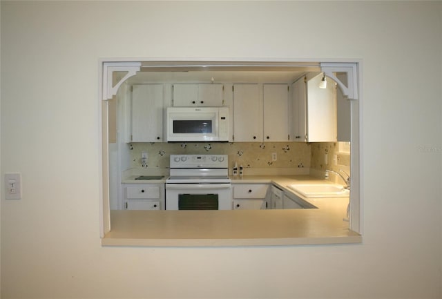 kitchen with tasteful backsplash, sink, and white appliances