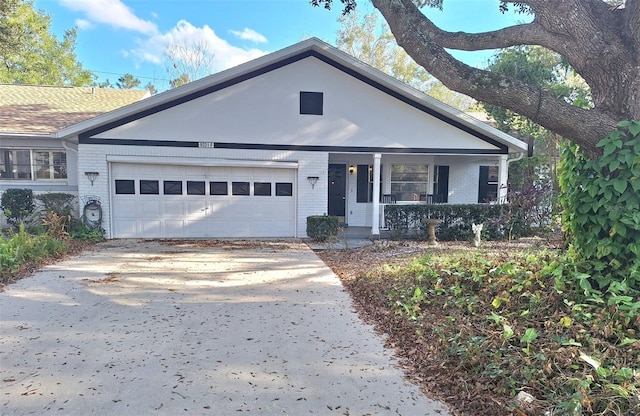 ranch-style home featuring a garage, concrete driveway, and brick siding