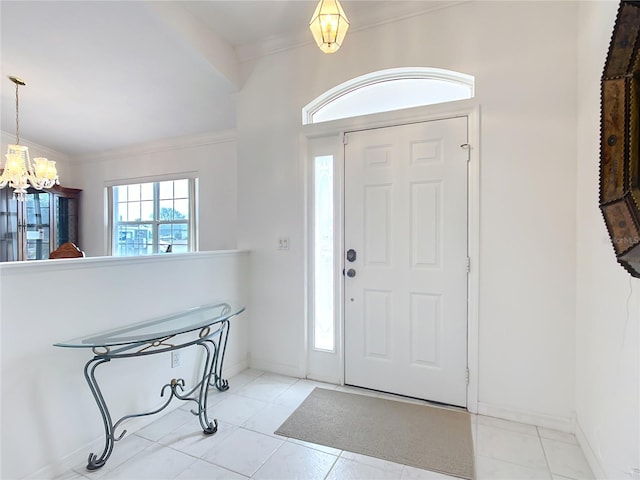 foyer featuring an inviting chandelier and ornamental molding