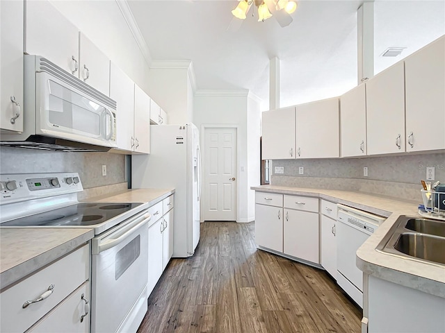 kitchen with white appliances, ornamental molding, decorative backsplash, and white cabinets