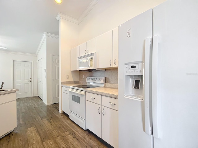 kitchen featuring hardwood / wood-style floors, white cabinetry, decorative backsplash, crown molding, and white appliances