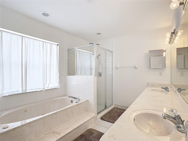 bathroom with tile patterned floors, vanity, and separate shower and tub