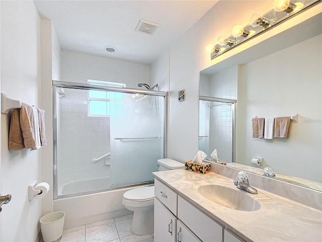 full bathroom with vanity, tile patterned floors, shower / bath combination with glass door, and toilet