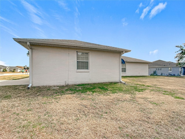 view of property exterior with a yard