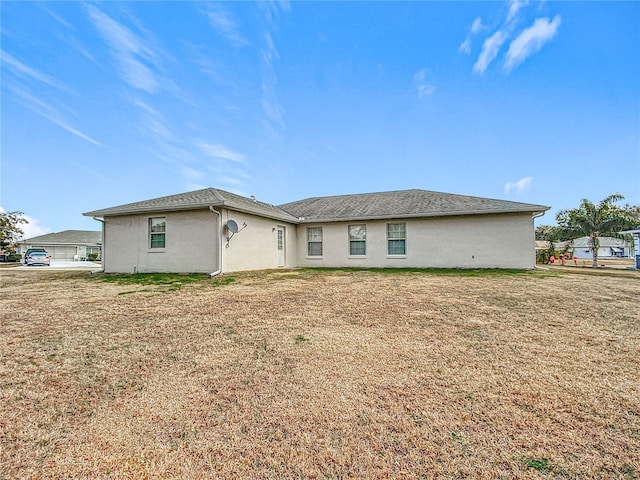 rear view of house with a yard