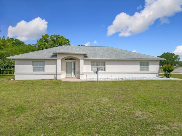 8574 SW 60th Ct, Ocala, FL 34476 - single story home with stucco siding, roof with shingles, and a front lawn