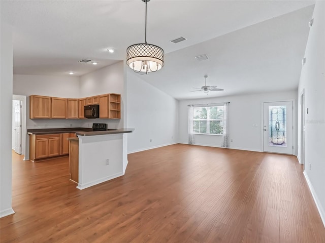 kitchen featuring lofted ceiling, hanging light fixtures, ceiling fan with notable chandelier, and light hardwood / wood-style floors