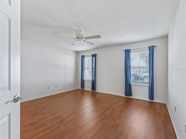 spare room with hardwood / wood-style floors, a textured ceiling, and ceiling fan