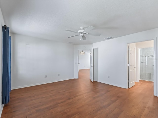 spare room featuring a textured ceiling, dark hardwood / wood-style floors, and ceiling fan