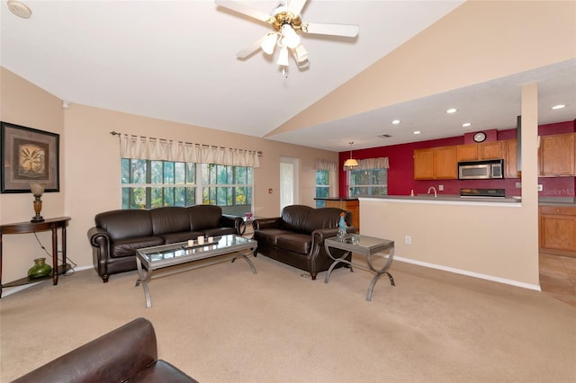 carpeted living room featuring lofted ceiling and ceiling fan