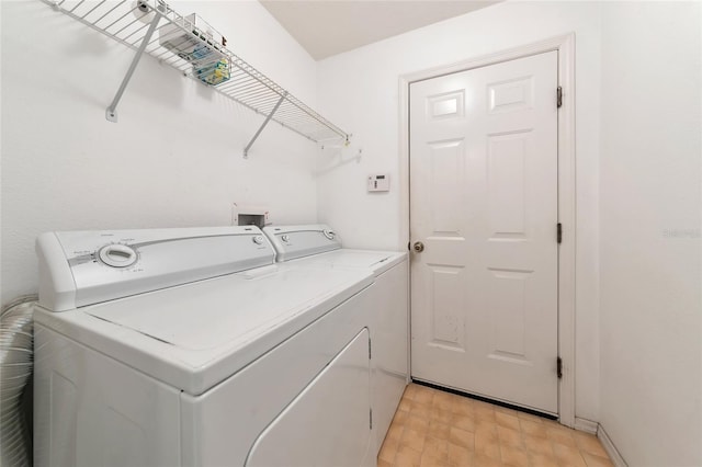 clothes washing area featuring independent washer and dryer