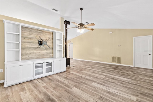 unfurnished living room featuring lofted ceiling, light hardwood / wood-style flooring, built in features, and ceiling fan