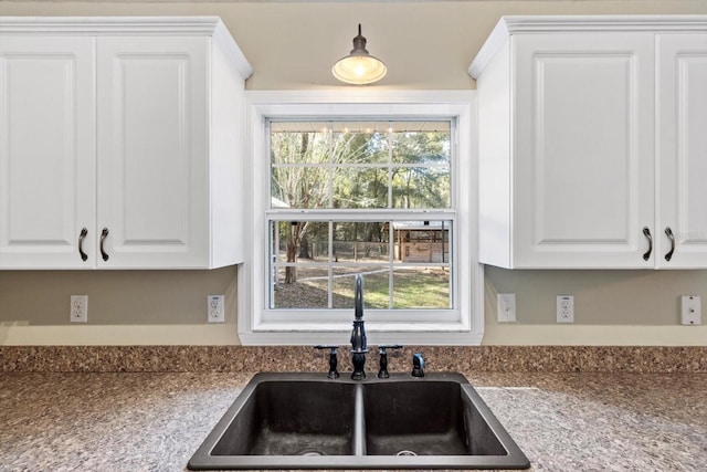 kitchen with white cabinetry and sink