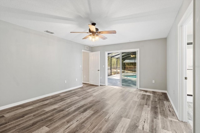 unfurnished room with ceiling fan and light wood-type flooring