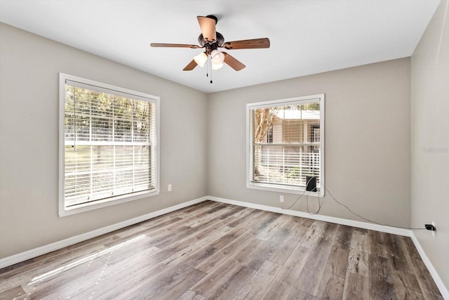 spare room with hardwood / wood-style flooring and ceiling fan